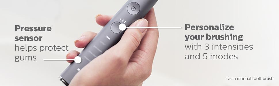person holding handle of grey toothbrush