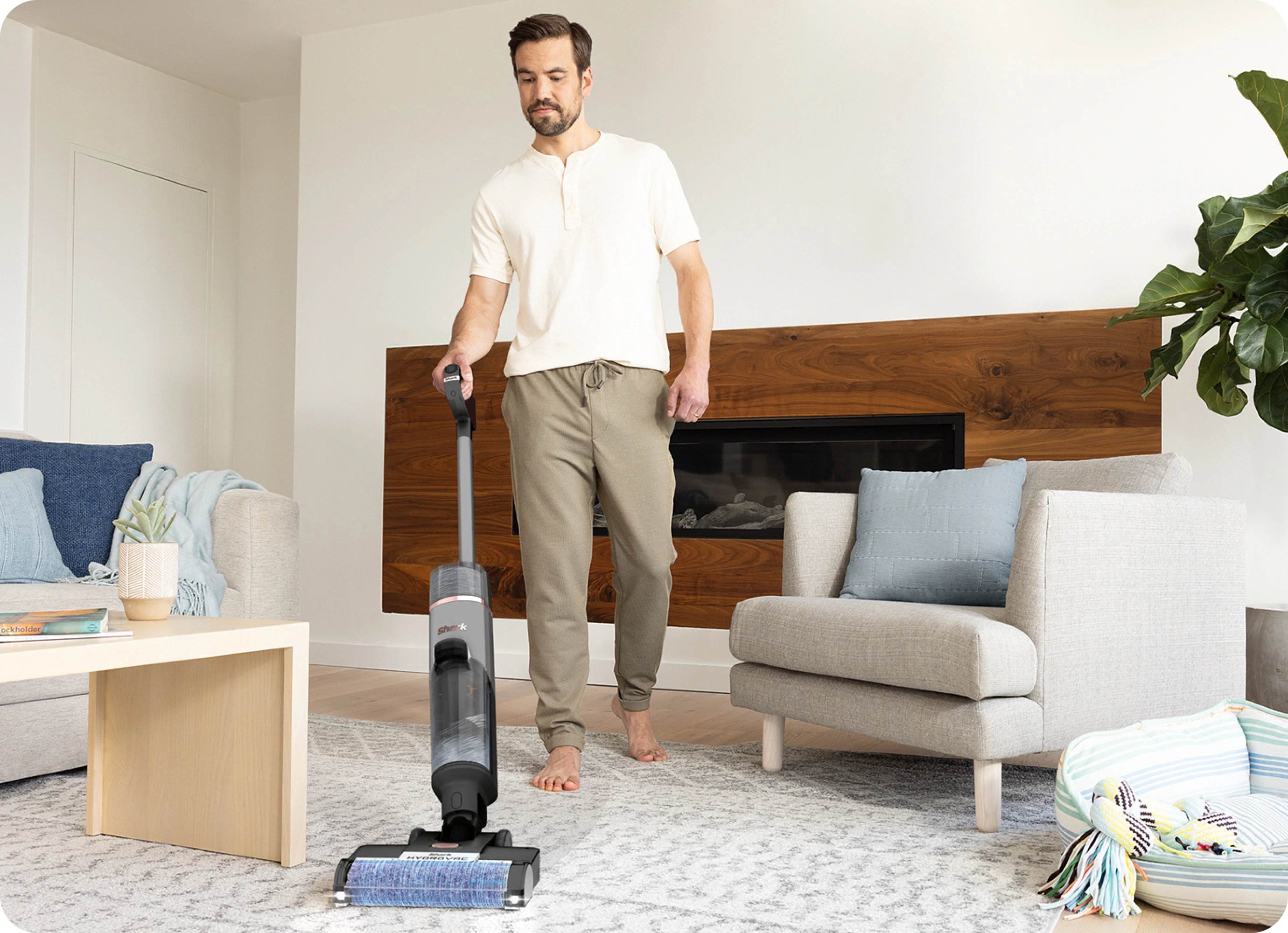 Man using vacuum in living room