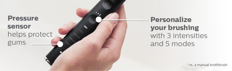 person holding black handle of toothbrush
